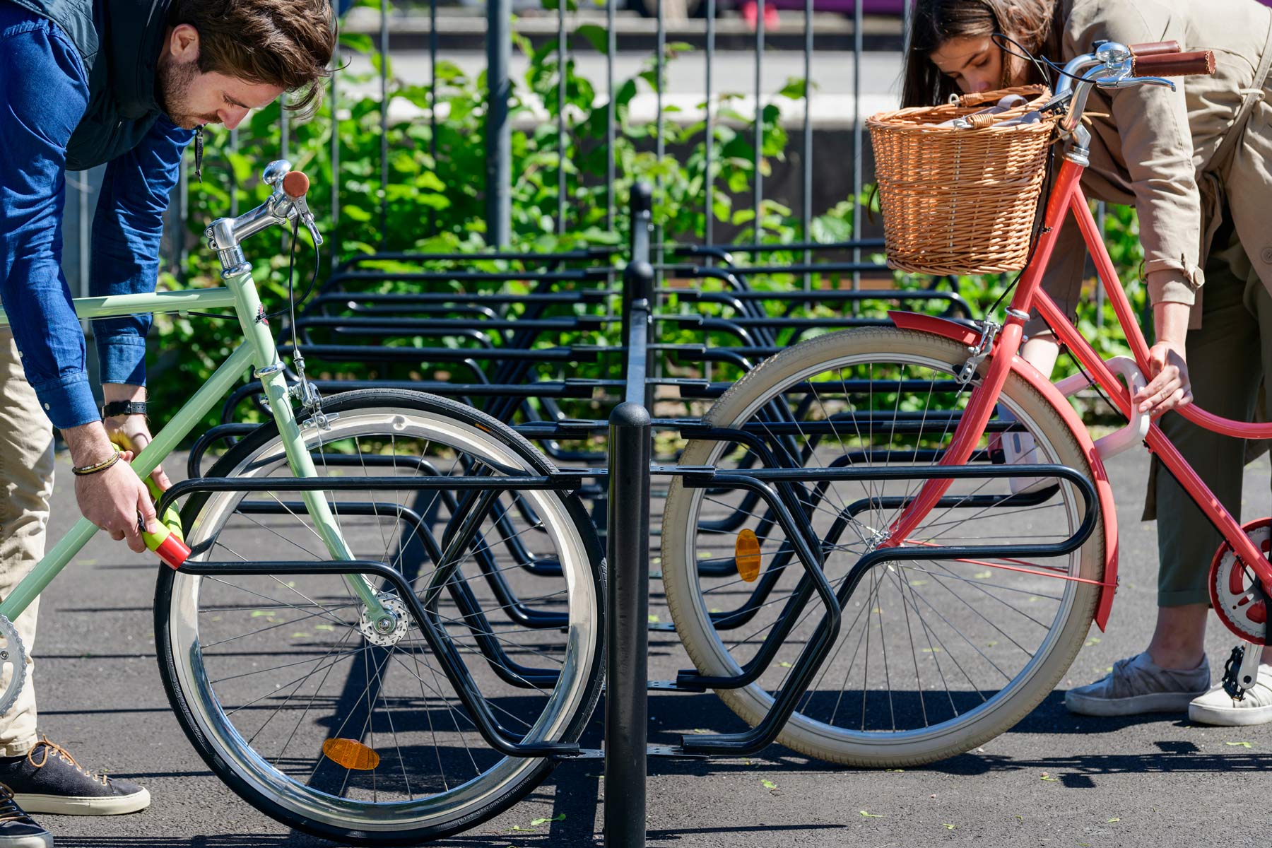 Cykelställ DELTA där två cyklister låser fast cyklarna i ramen