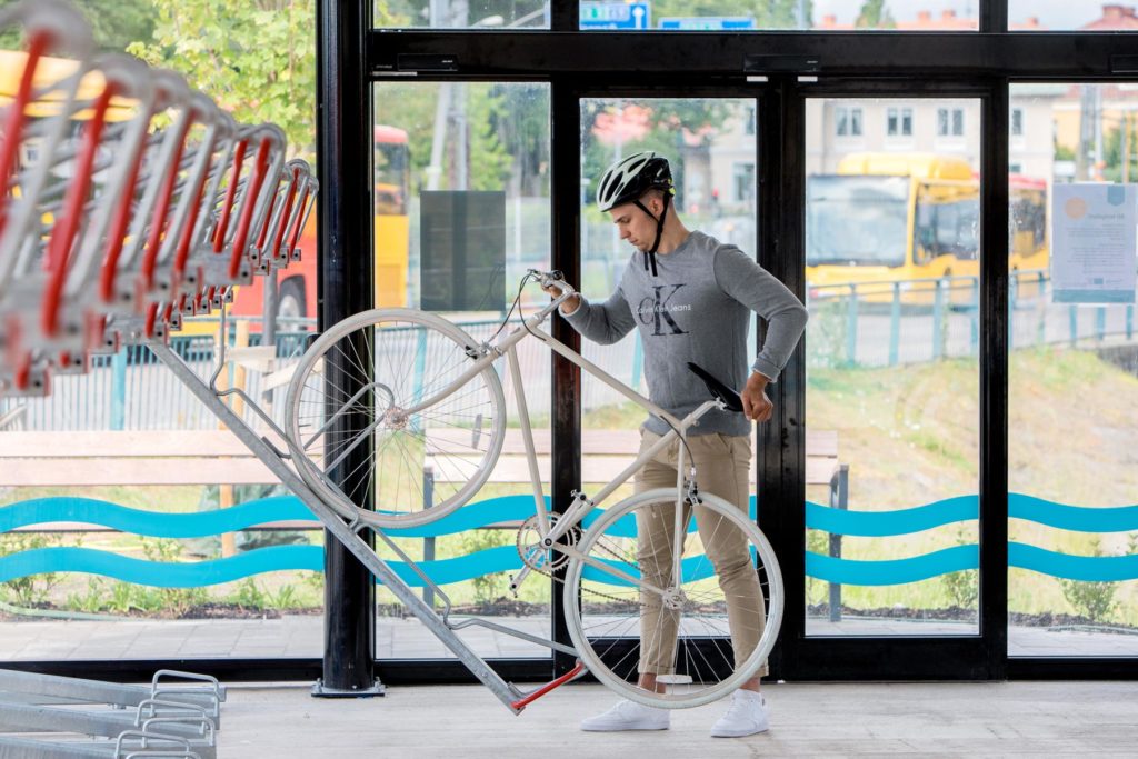 Cyklist som använder 2-våningsställ i ett cykelgarage